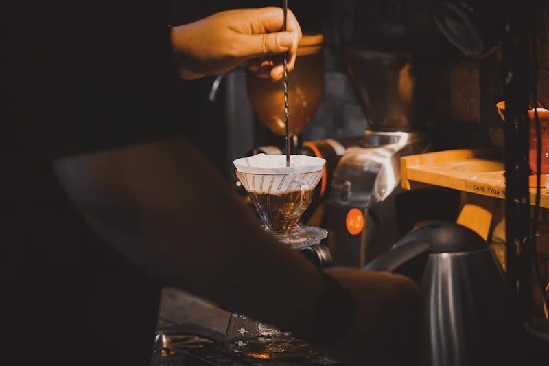 Pour-over coffee instructor giving feedback during a student's brew