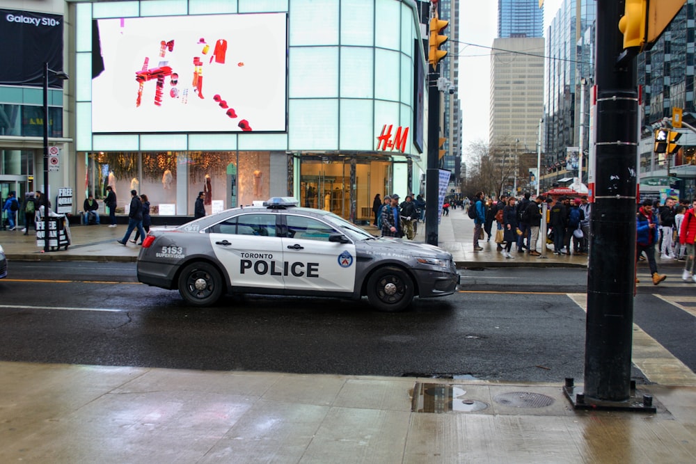 black and white police car on road