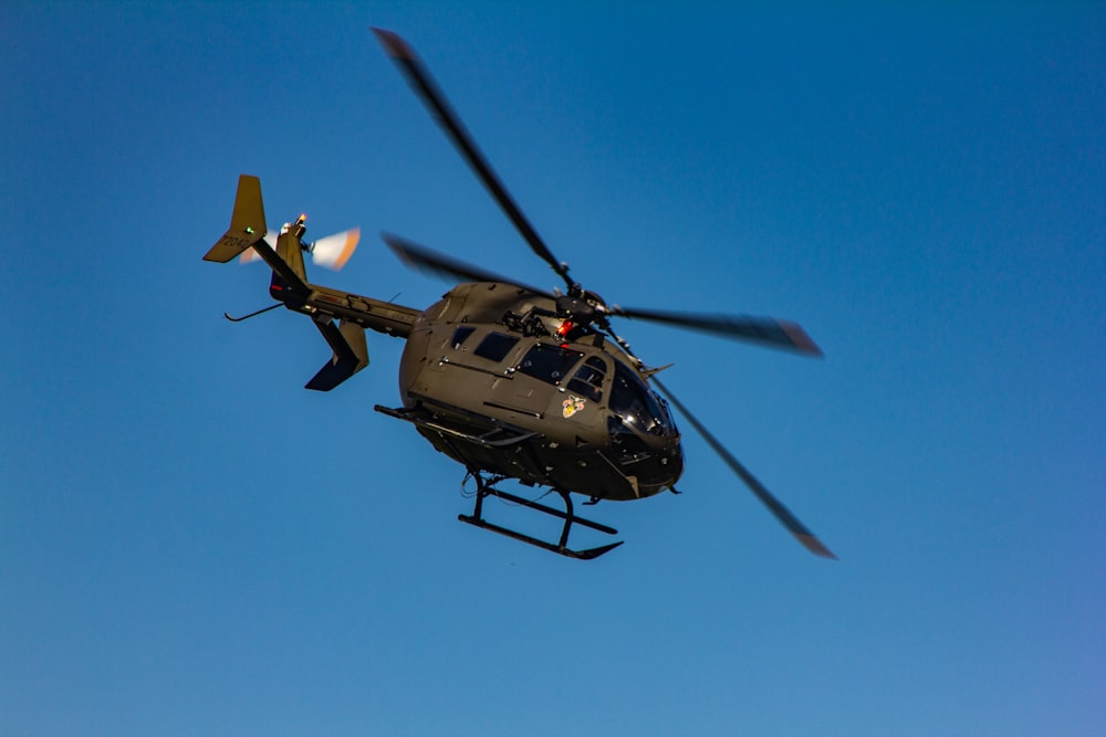 brown helicopter in flight