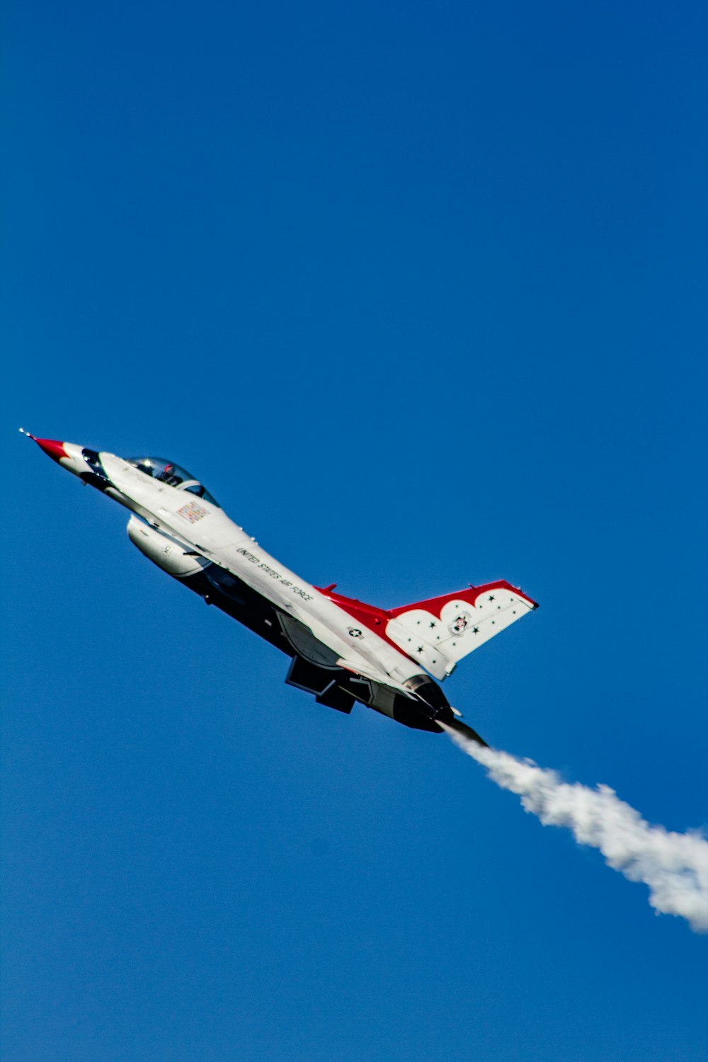 white and red plane on sky