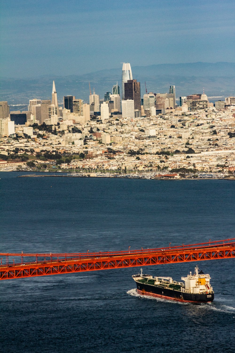 black and red boat crossing channel