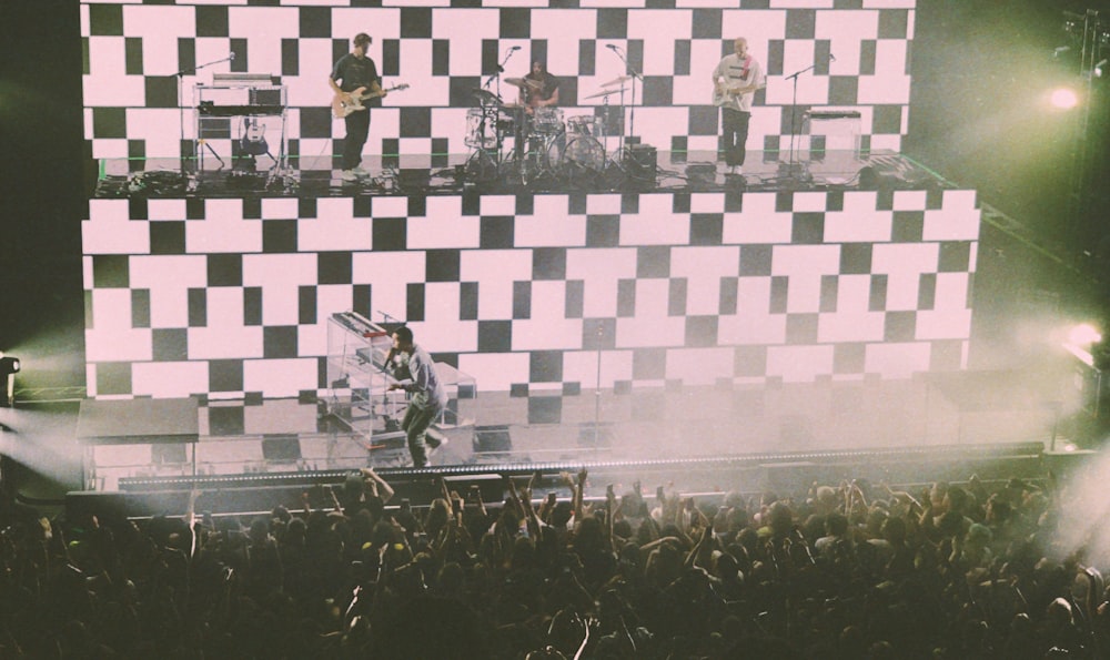 band performing on black and white 2-tier stage