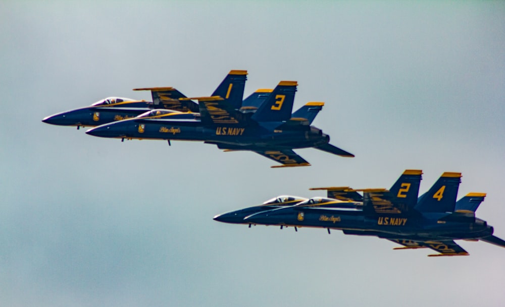 two blue-and-yellow fighter planes in the sky