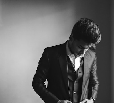 Full-length shot of a formal suit featuring minimalist design and soft ivory tones.