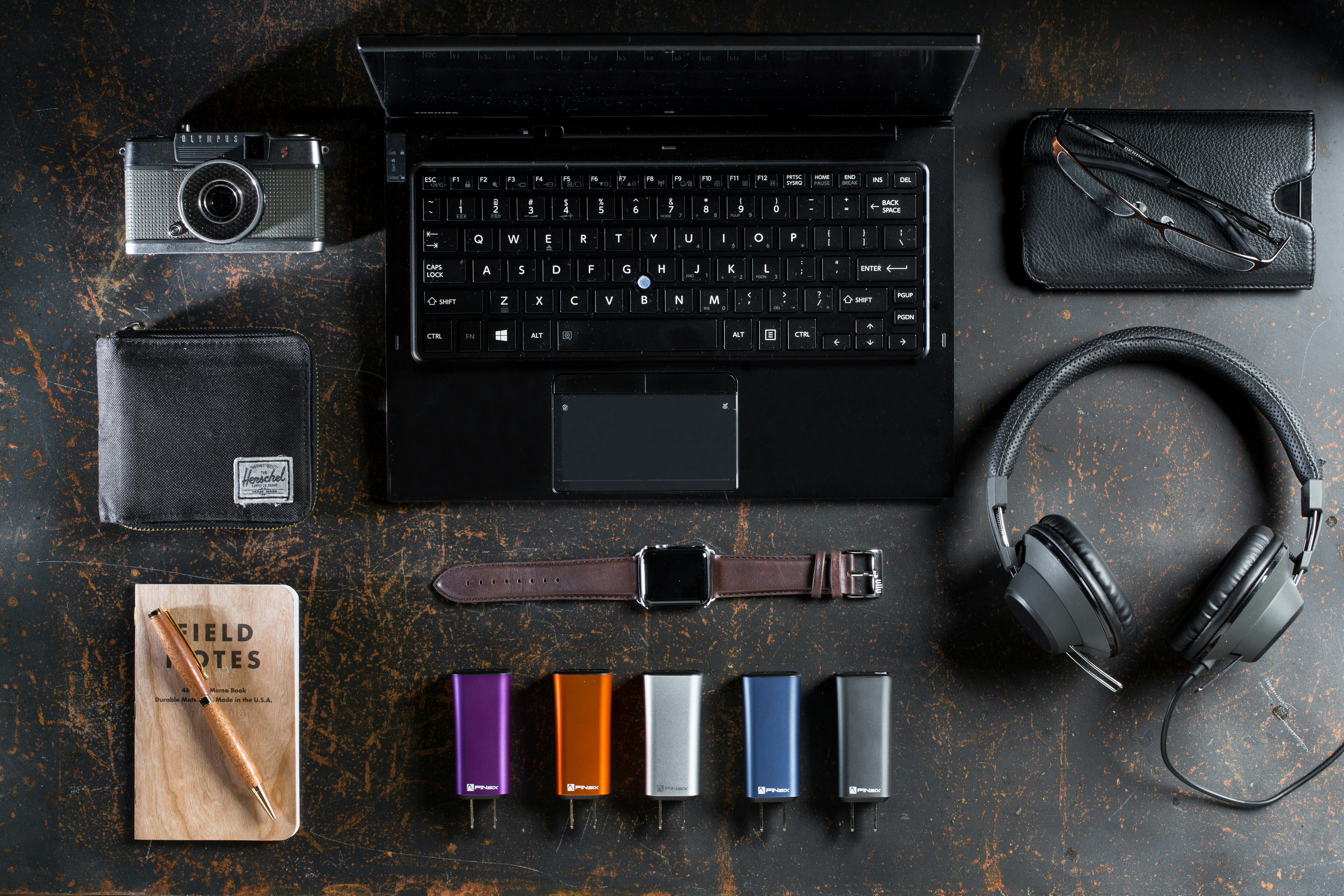 flat lay photography of laptop, headphones, and smartwatch