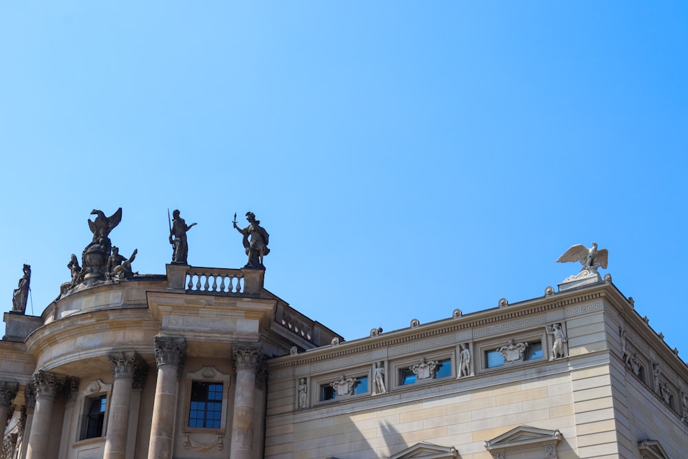 black and grey statues on top of building