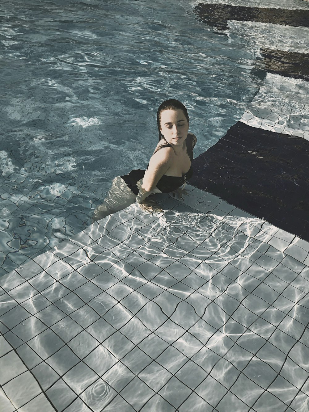 woman in black bikini in pool