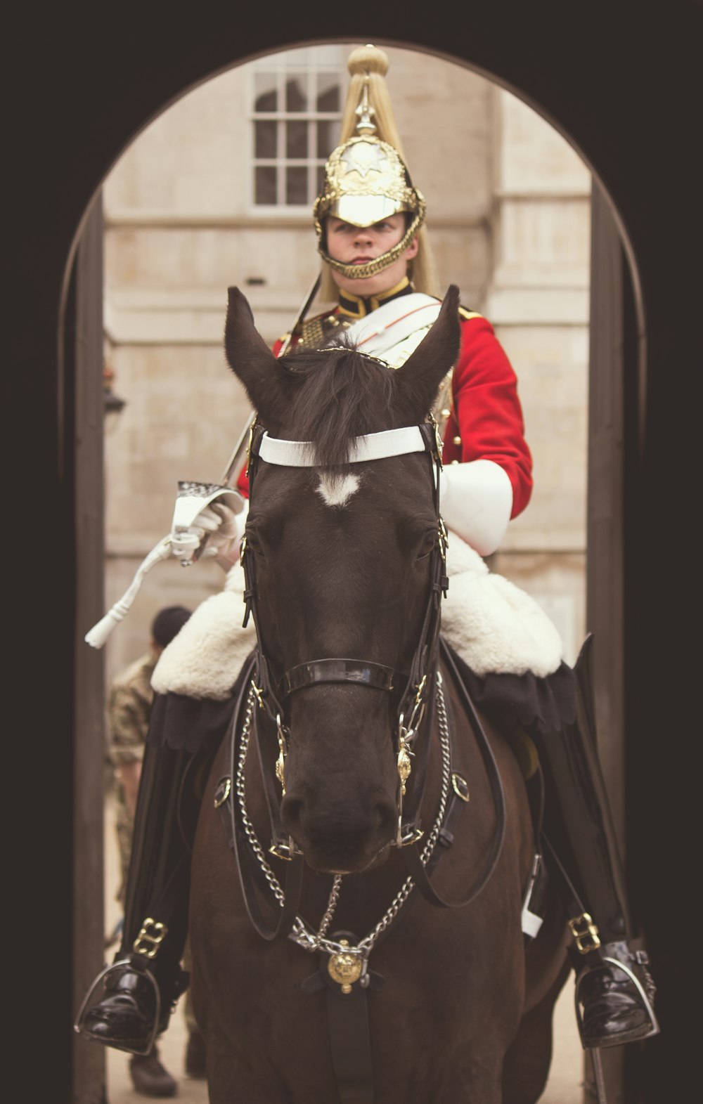 man riding on black horse during daytime