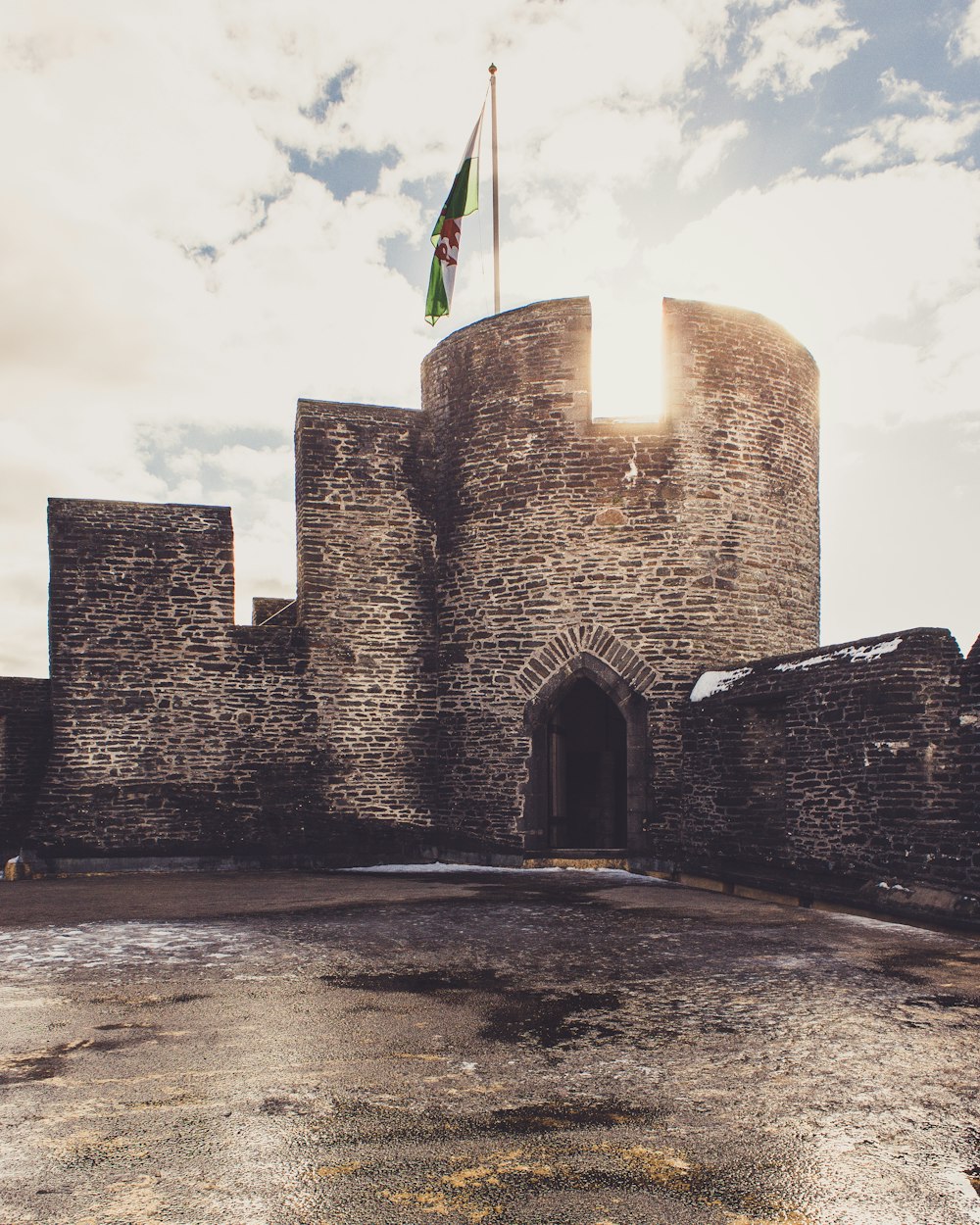 brown castle with flag on top under white skies