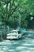A sleek white taxi parked near the lush greenery of Jim Corbett National Park entrance