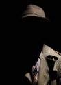 person wearing gray plaid notched lapel suit jacket and gray hat hiding face