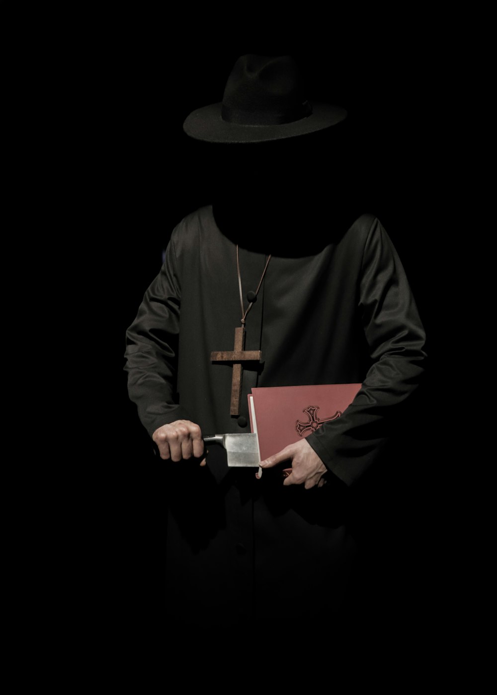 man wearing long-sleeved top holding bible