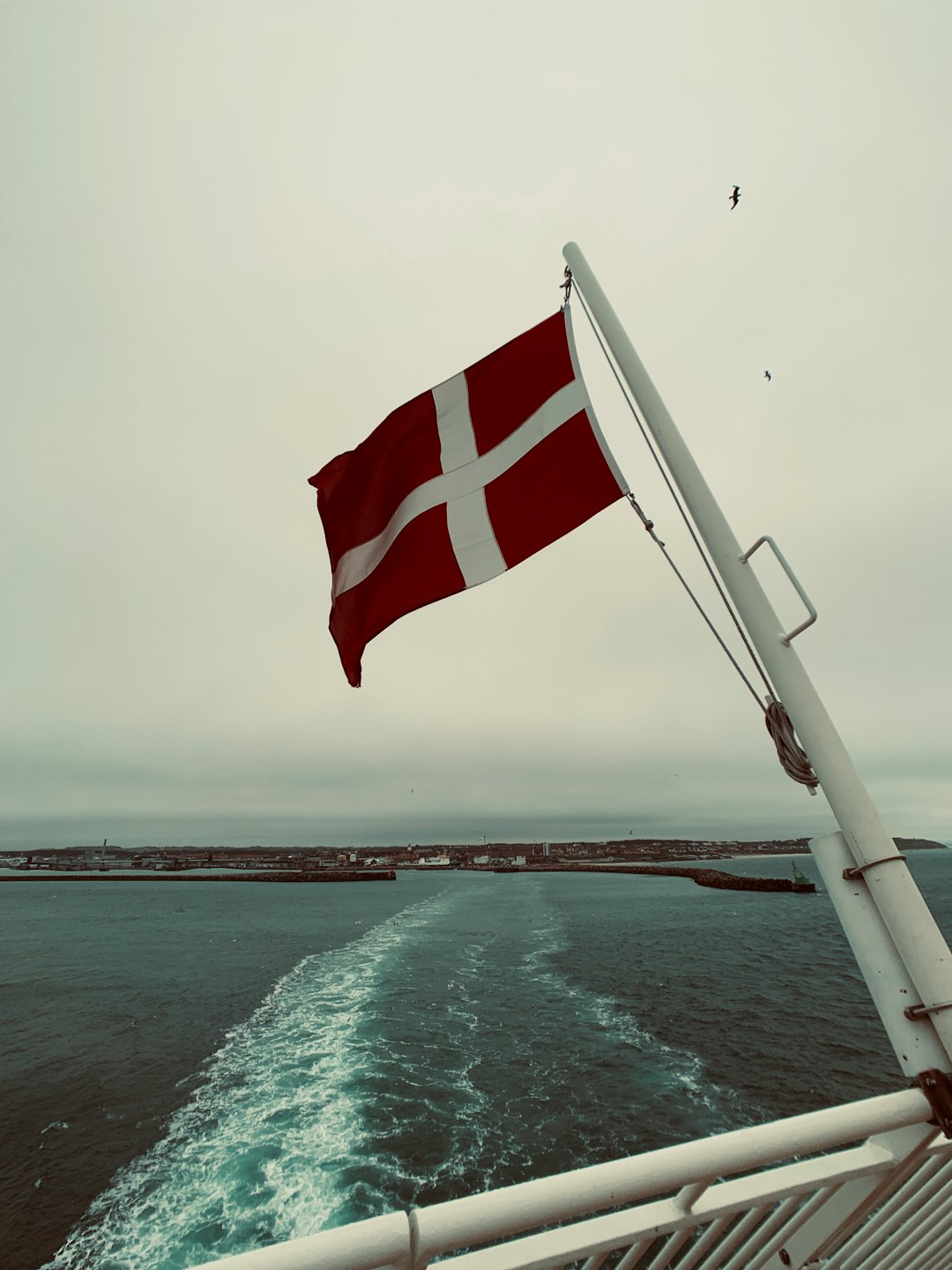 waving flag in pole attached to ship