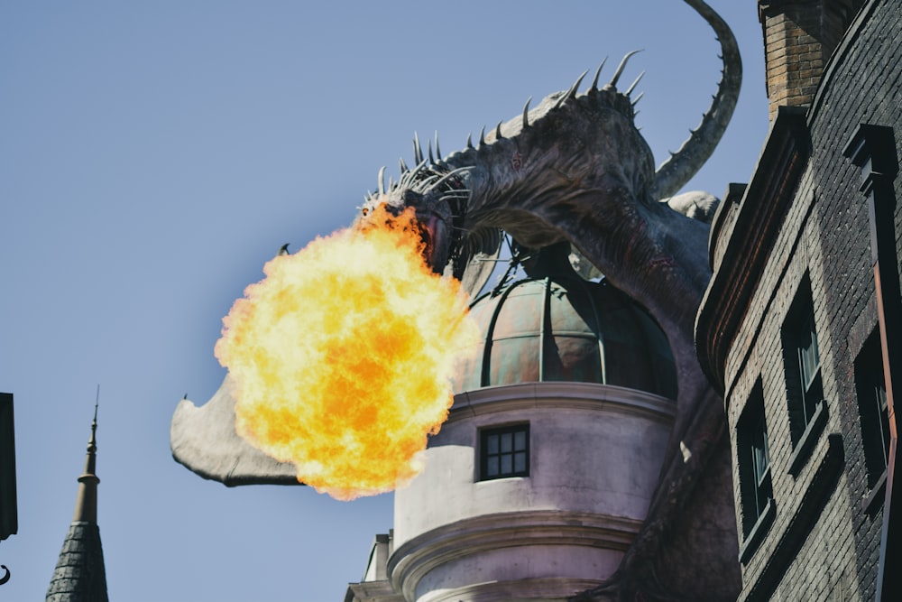 fire breathing dragon figure on building rooftop