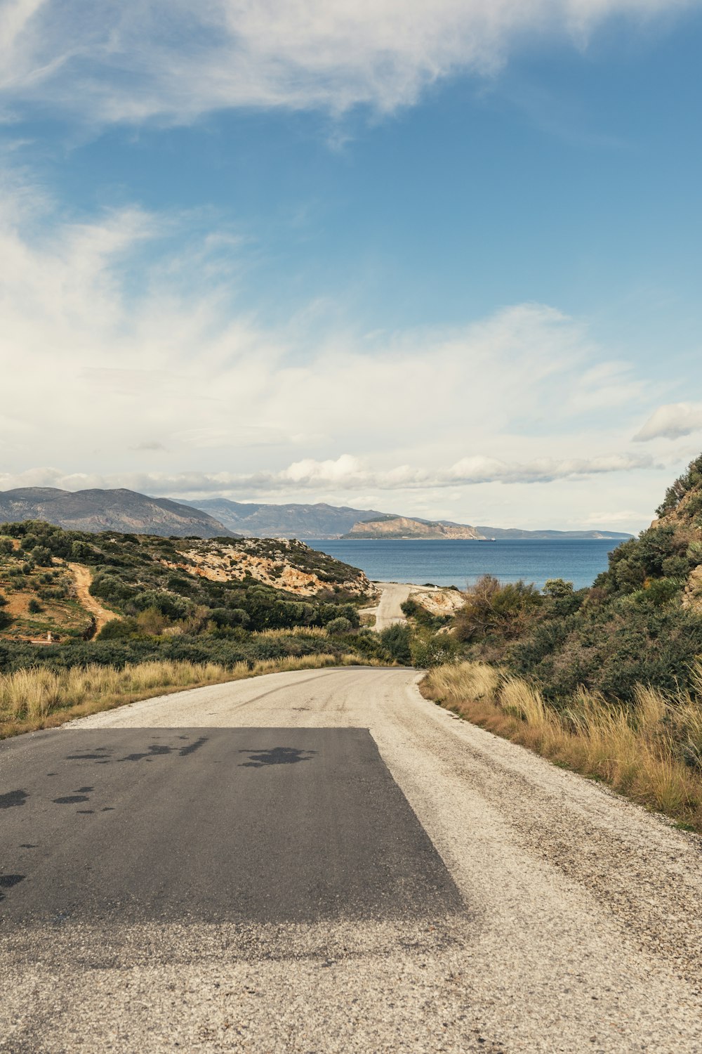 gray concrete road under clear blue sky