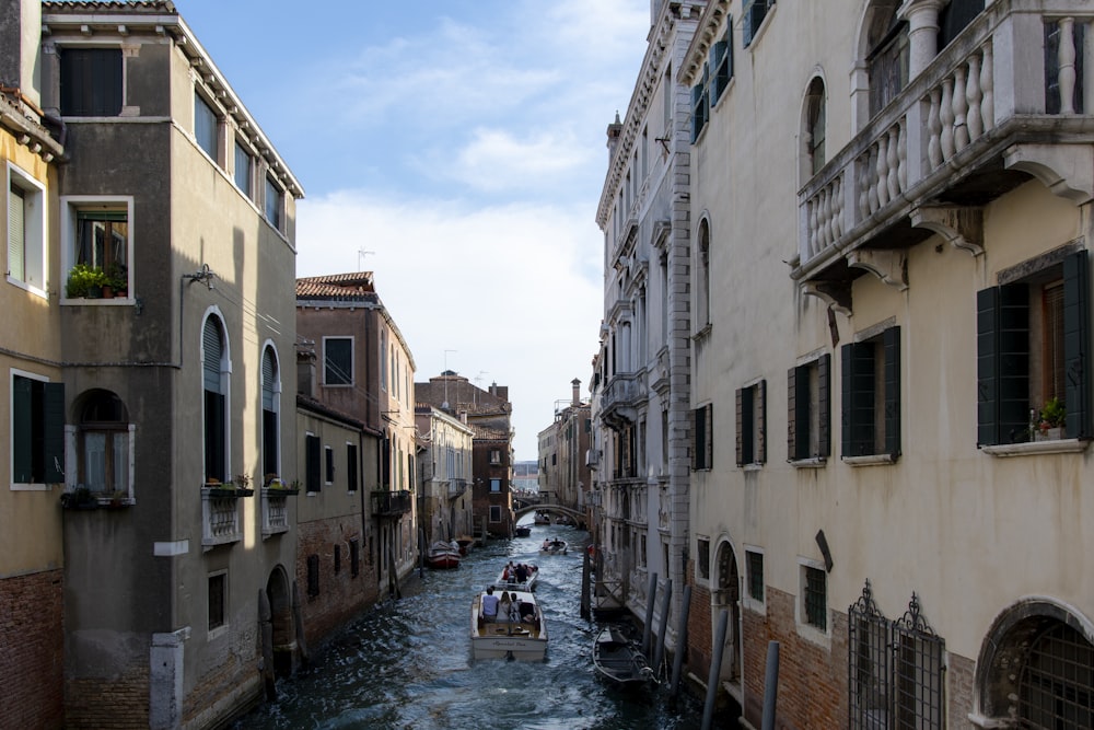 gray boat on river surrounded by buildings