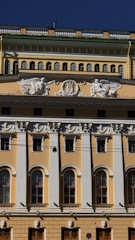 Facade of a commercial building with newly applied decorative plaster in yellow tones