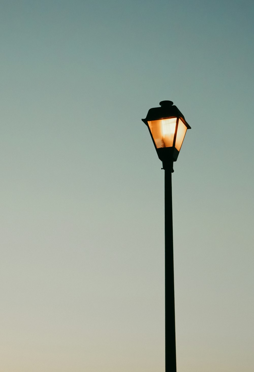 poste de luz preto e laranja iluminado