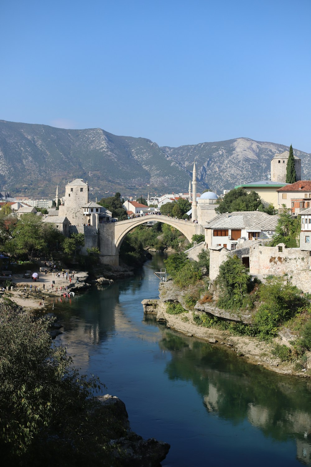 people gathering on bridge above river