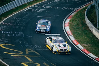 Two running cars on race track