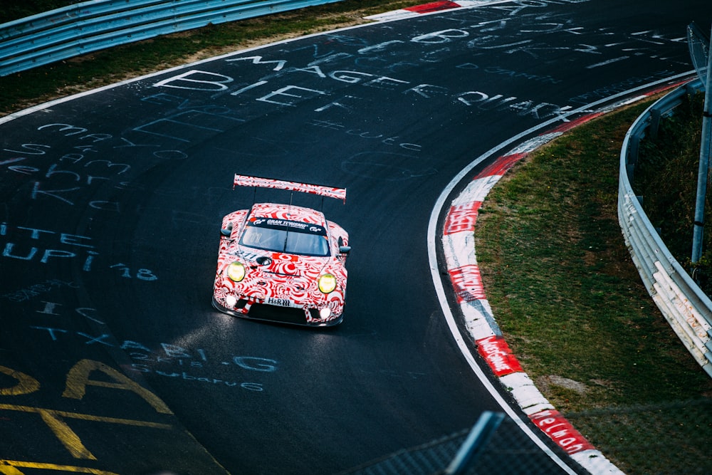 red and white racing car on road