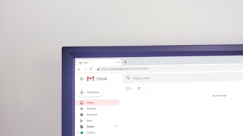 A computer screen displaying the Gmail inbox page, with the Compose button on the left and various email categories like Starred, Snoozed, and Sent. The address bar shows the URL for the inbox. The words 'No new mail!' are visible on the right side.