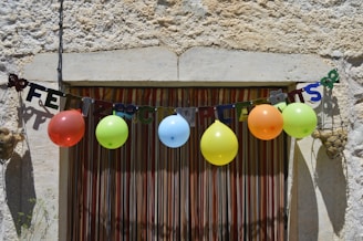 A lively birthday party scene with colorful decorations, friends cheering, and Ricky smiling warmly.