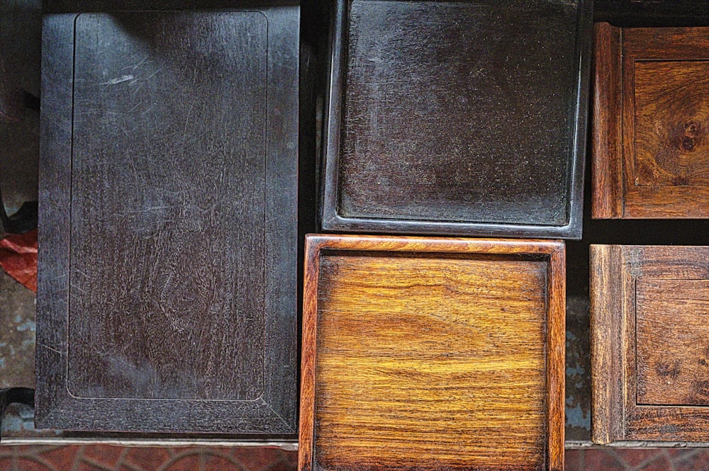 five brown and black wooden chairs