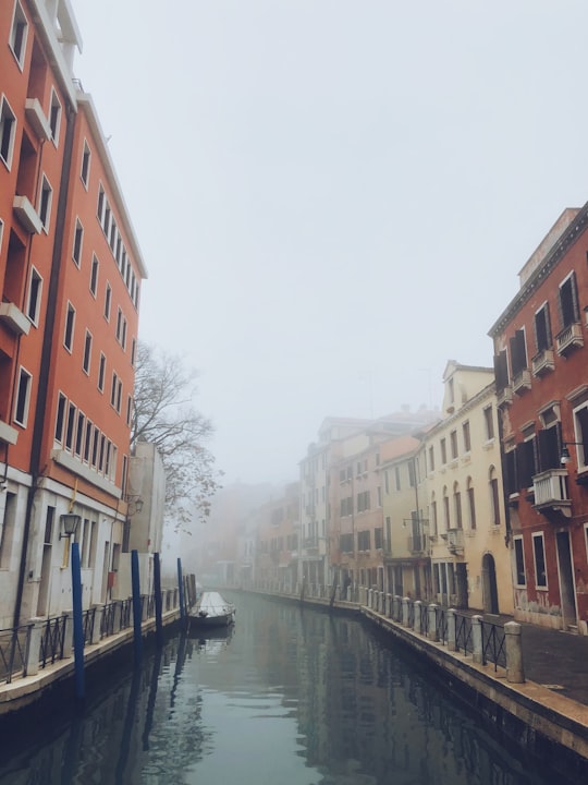 brown and white concrete buildings covered with fogs in Trattoria Agli Amici Italy