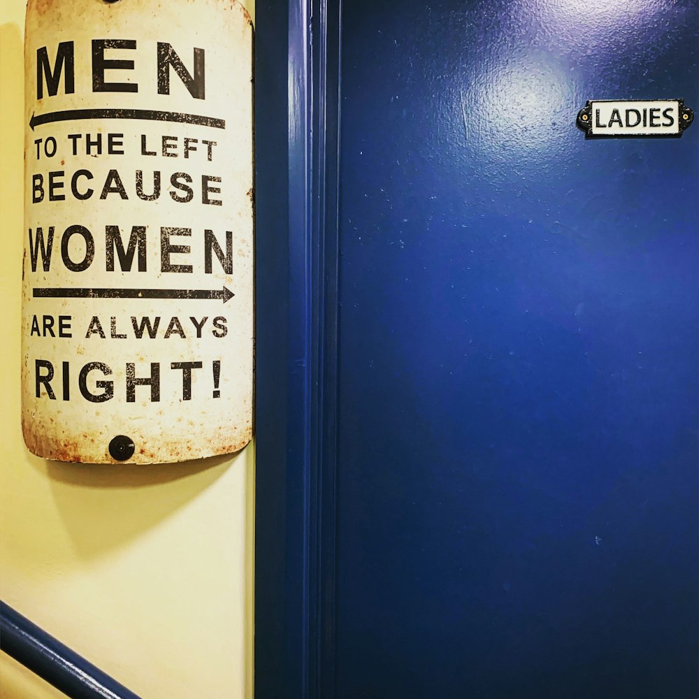 a blue door with a sign that says men to the left because women are always