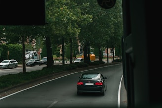 black BMW car on road during daytime