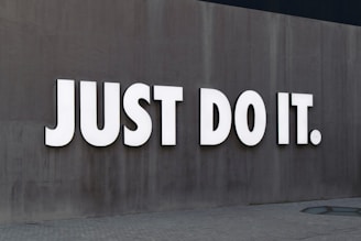 white Just Do It. wall sign