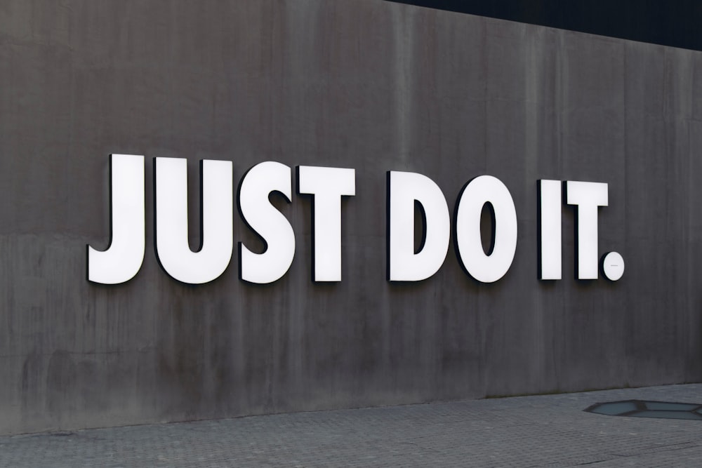 white Just Do It. wall sign