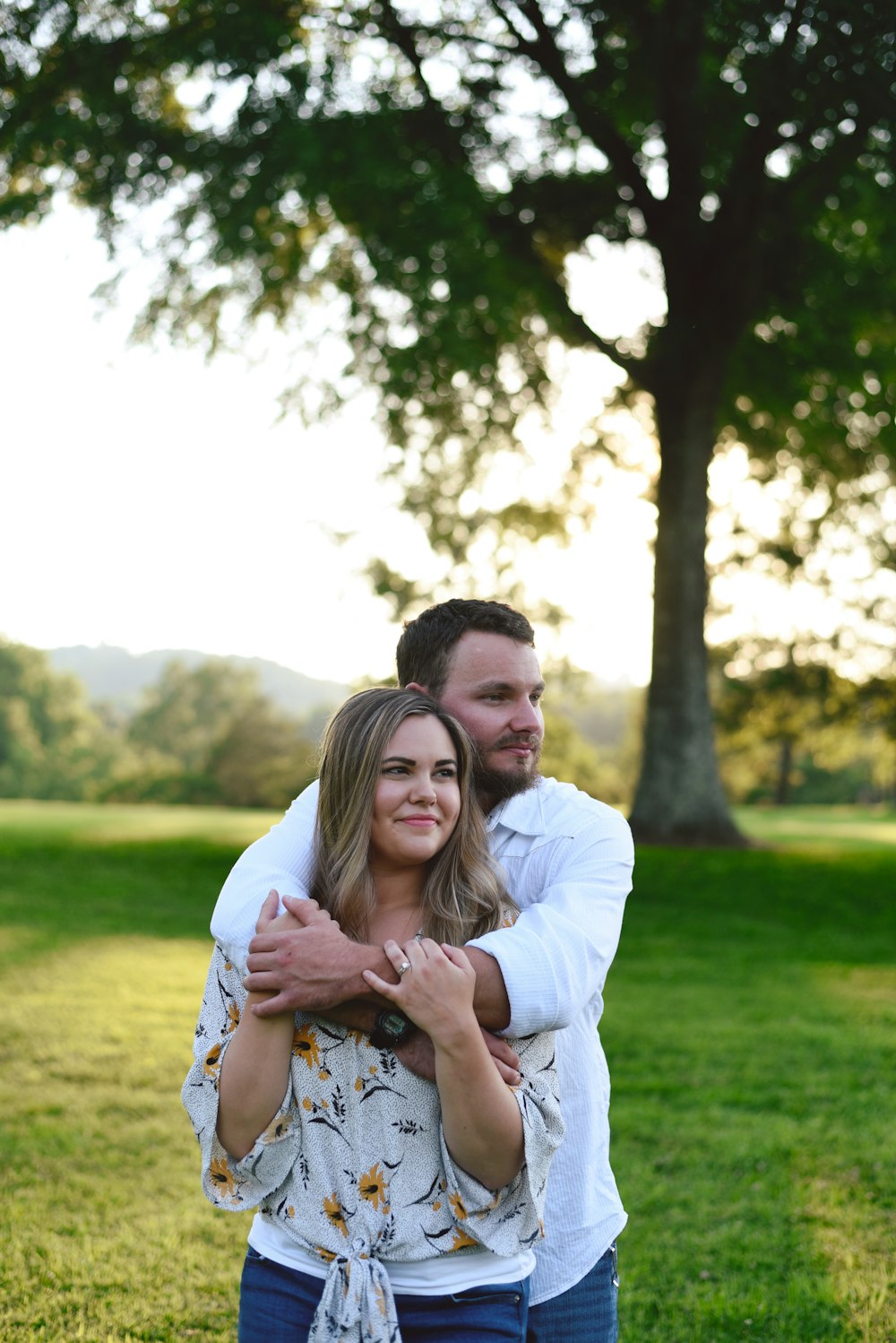 man and woman at a green field