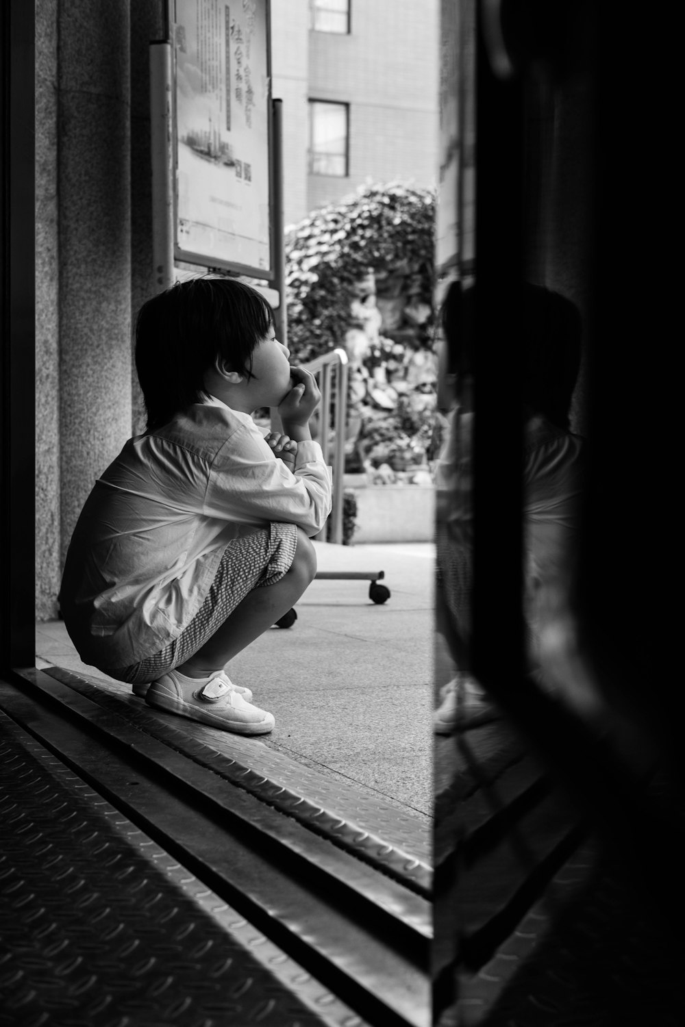 child sitting at the entrance