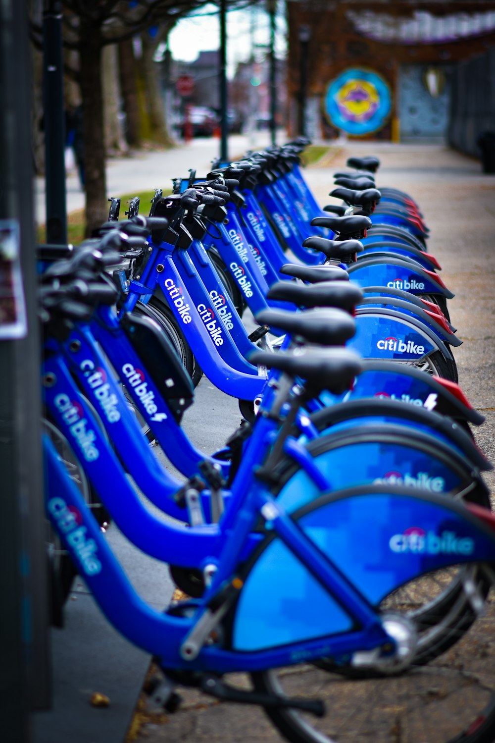 a row of blue bicycles parked next to each other