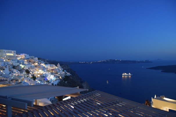 Evening view of Porto Cervo coastline with lights reflecting on the calm sea