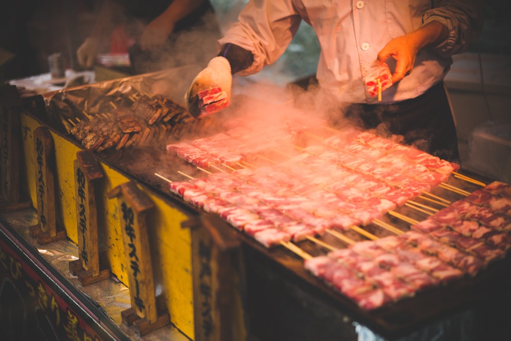 man grilling meat