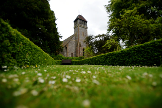 A serene church surrounded by flourishing gardens symbolizing growth and stewardship.