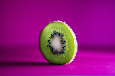 Bright green kiwis sliced to show their juicy interior.