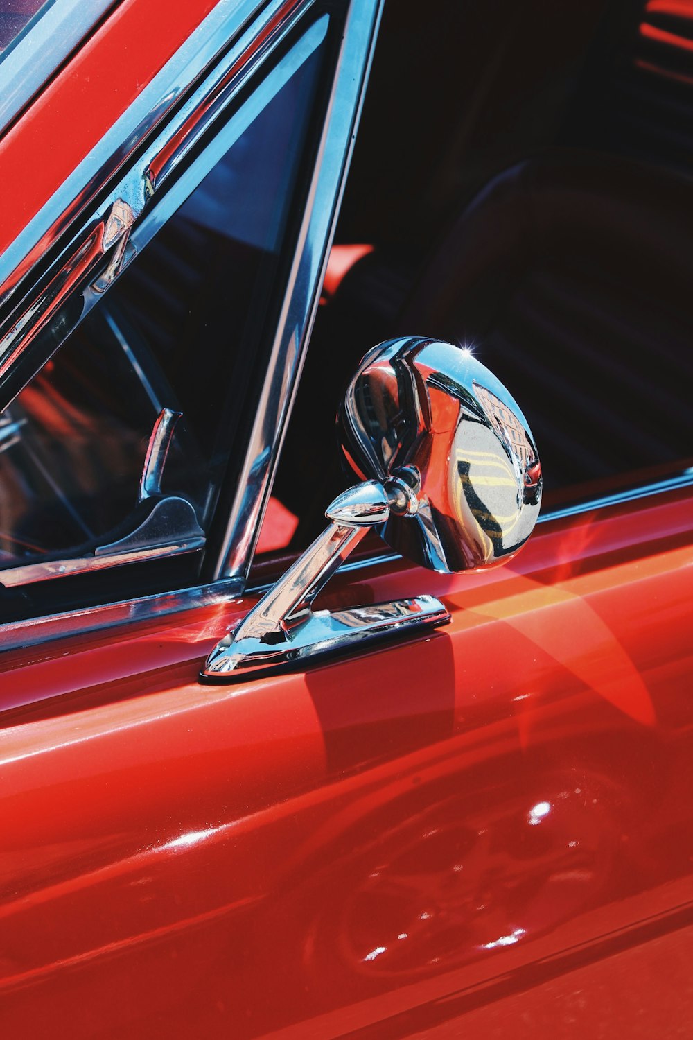 a close up of a red car door handle