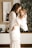 smiling woman in white dress holding toddler