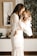 smiling woman in white dress holding toddler