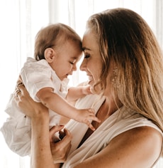 smiling woman carrying baby