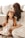 a woman sitting on the floor with a little girl