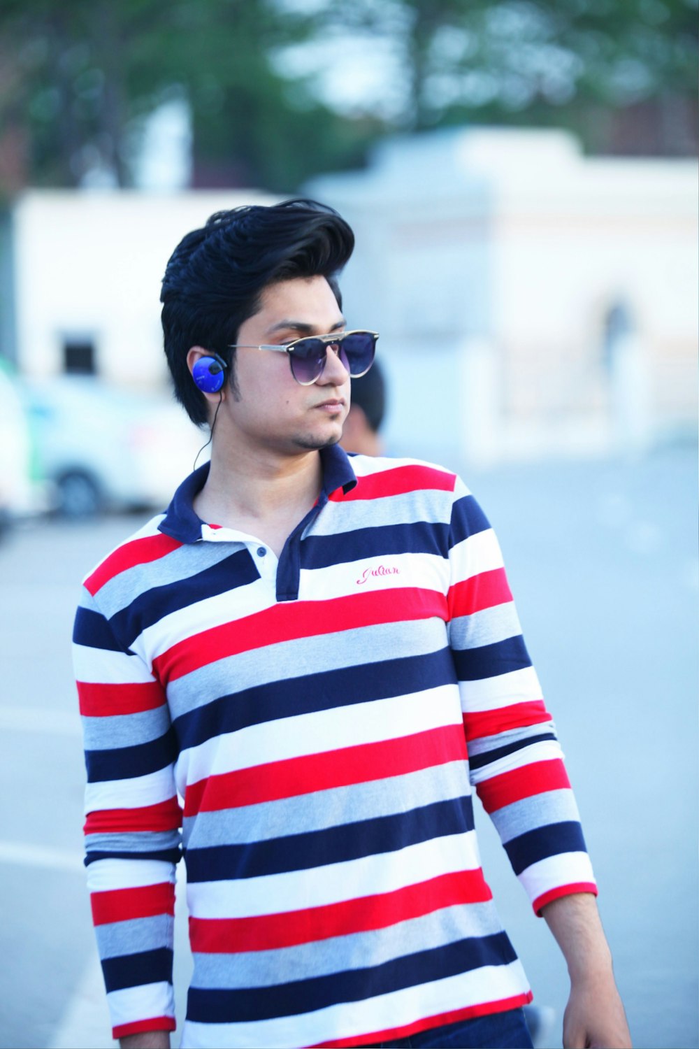 man wearing red and white striped shirt