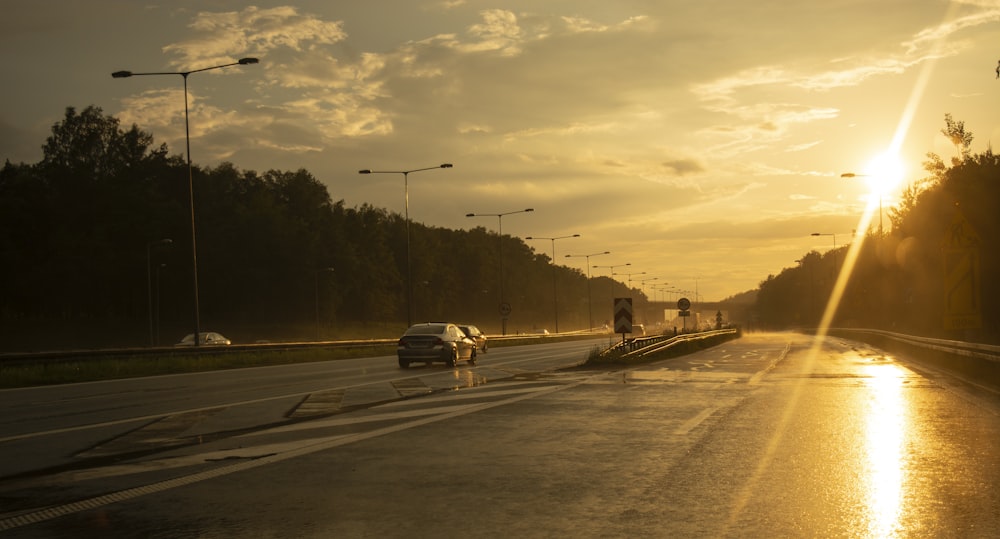 cars running on road during golden hour