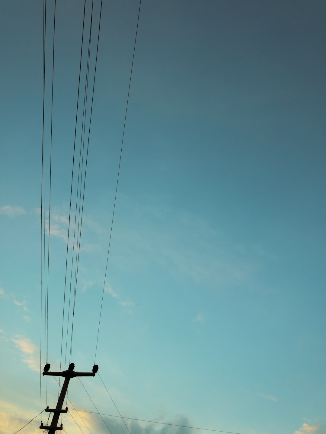 silhouette of power lines and post