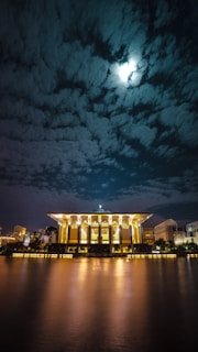 brown building near body of water during nighttime