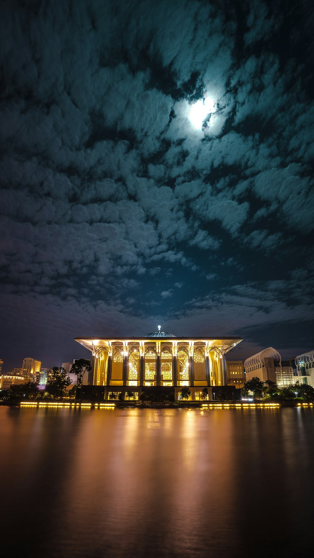 brown building near body of water during nighttime